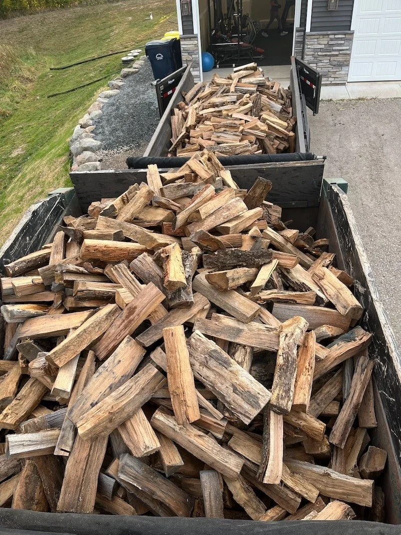 Stacked firewood in the back of a truck